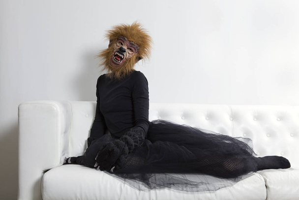 werewolf woman wearing a tutu and sitting on a white sofa - Φωτογραφία, εικόνα