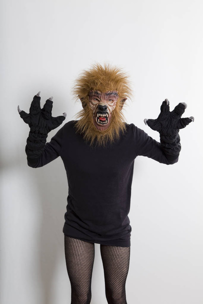A sexy woman wearing a werewolf mask and fishnet tights - Фото, зображення