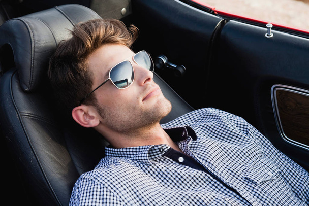 man lying in front seat of car - Foto, Imagem