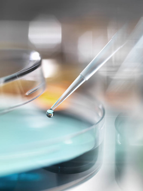 Scientist pipetting sample into a petri dish in a laboratory - Fotoğraf, Görsel