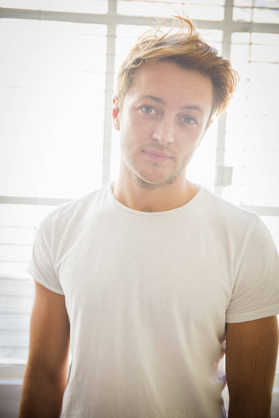 Portrait of young man wearing white t-shirt - Photo, Image