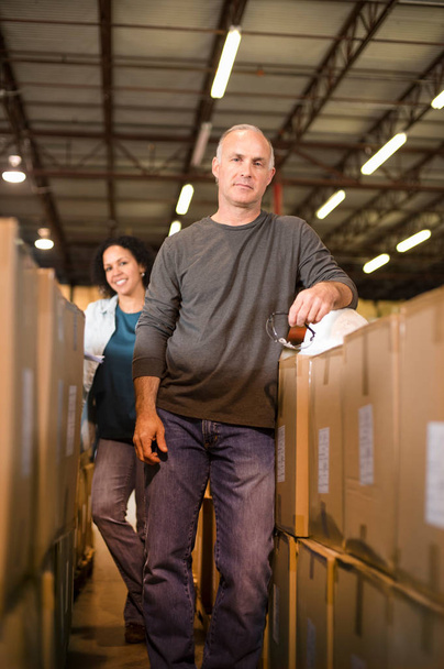 Portrait of warehouse workers by cardboard boxes - Foto, Imagem