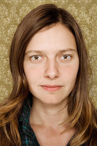 Portrait of mid adult woman with star shaped eyes - Foto, afbeelding