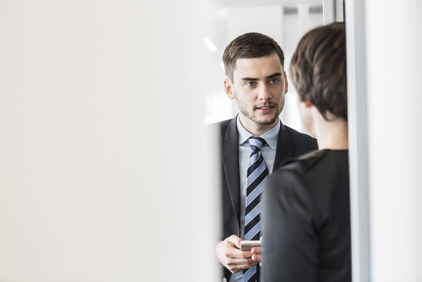 Businessman talking to woman - Фото, изображение