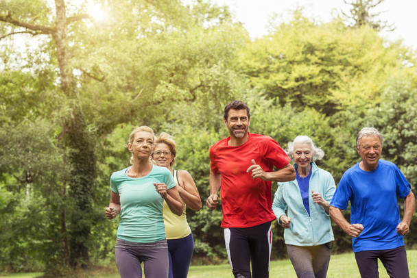Group of adults running outdoors - Foto, Imagem