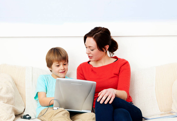 Mother and son using laptop together - Photo, image