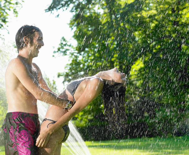 Couple dancing under a water-jet - Photo, Image