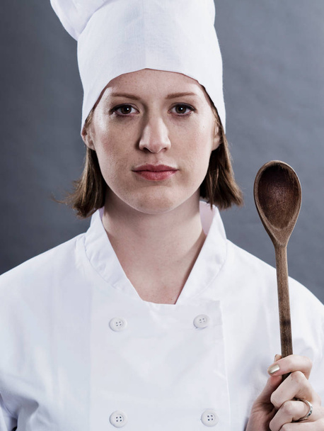 Chef holding wooden spoon - Foto, imagen
