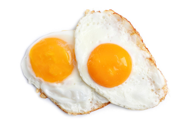 Sabrosos huevos soleados boca arriba sobre fondo claro
 - Foto, Imagen