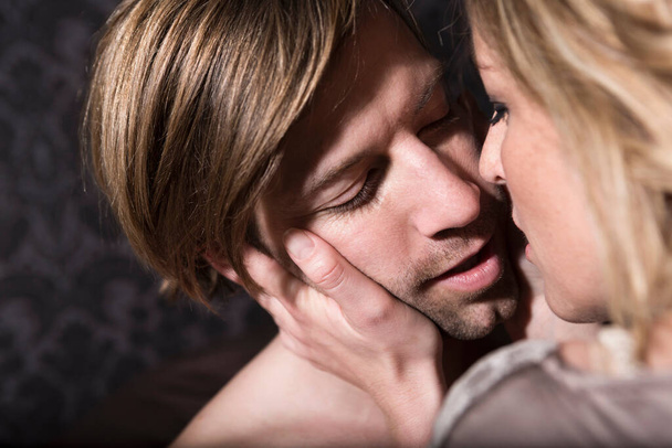 Heterosexual Couple hugging in bedroom - Foto, immagini