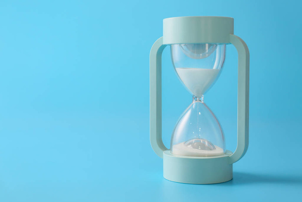 Hourglass on color background. Time management concept - Photo, Image