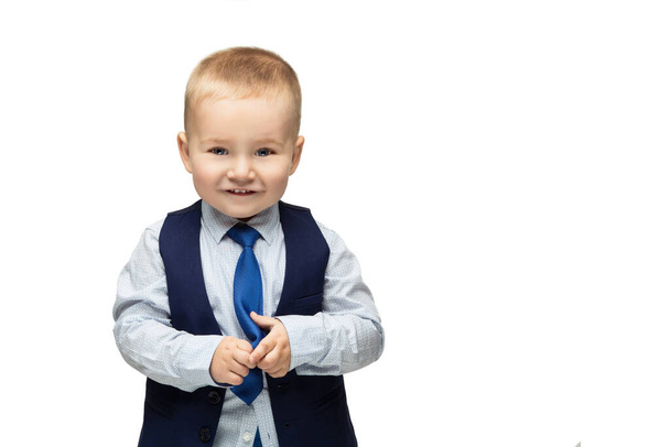 Cute baby boy in shirt, vest and tie with funny expression on face. Isolated over white background. Copy cpace. - 写真・画像