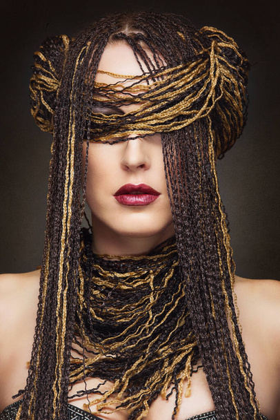 Closeup portrait of beautiful caucasian young woman with many african braids - Foto, imagen