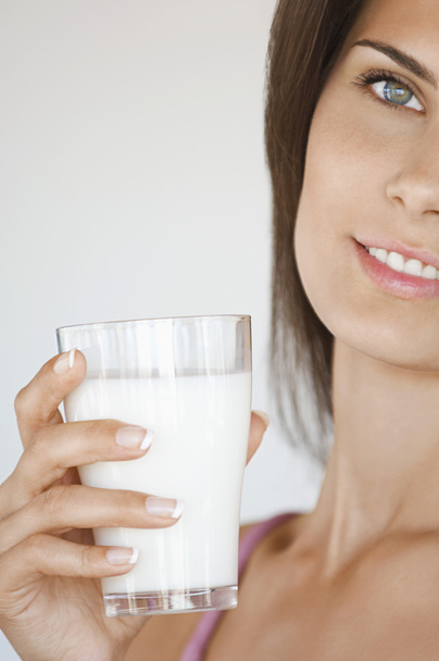 Woman Holding Glass of Milk - 写真・画像