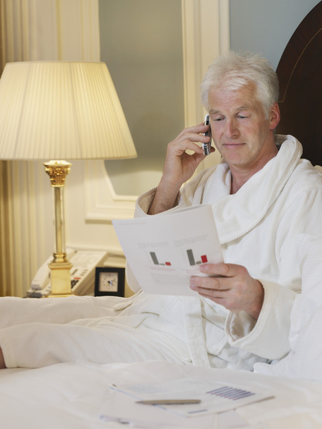 Businessman Reading and Phoning - Фото, изображение