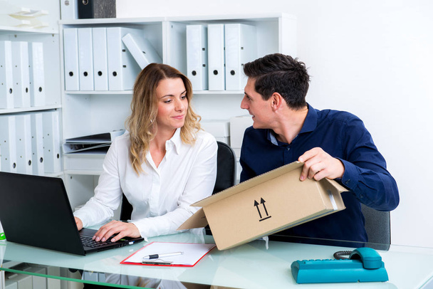 young businessman and businesswoman with delivery in the office - Photo, image