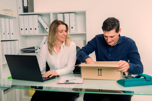 young businessman and businesswoman with delivery in the office - Foto, imagen