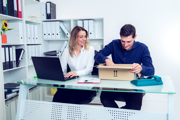 young businessman and businesswoman with delivery in the office - Photo, image