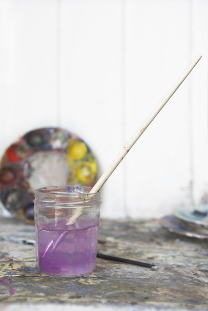 Paintbrush in glass in artist's studio - Φωτογραφία, εικόνα