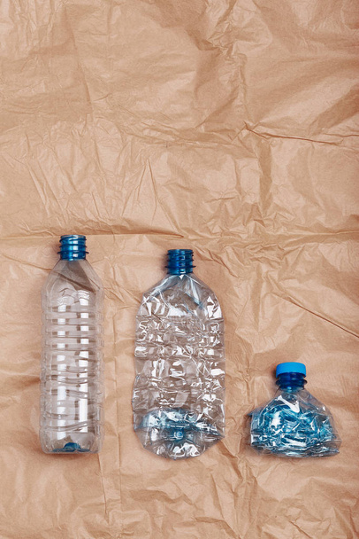 Squashed empty plastic bottles put in a row - Foto, Imagen