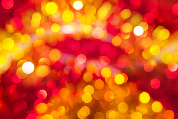 Abstract festive blurry background with bokeh yellow and red col - 写真・画像