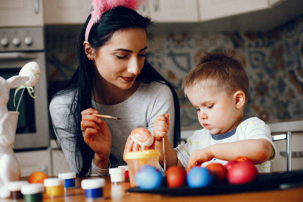 Mother with little son in a kitchen - Фото, изображение