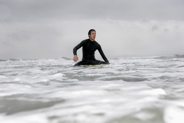Man on surfboard in ocean - 写真・画像