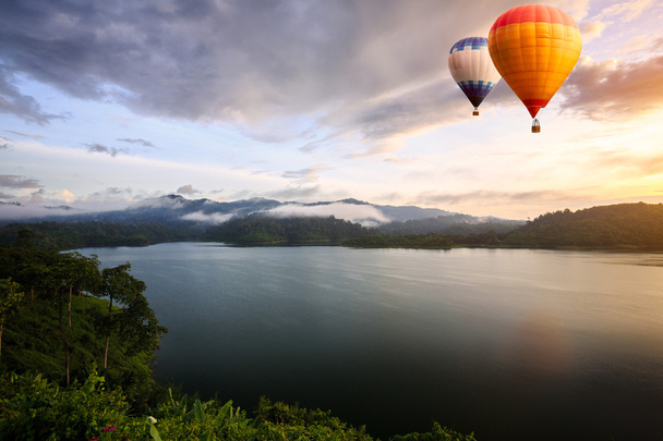 Hot air balloons floating over lake - Photo, Image