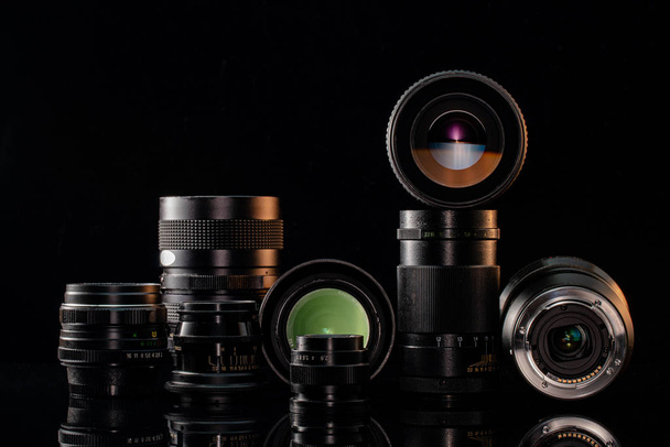 Vintage and modern lenses for the camera on a black background - Foto, Imagem