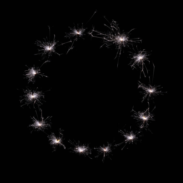 bright burning sparklers against a dark background. - Foto, afbeelding