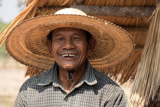 portrait of an old asian man with straw hat - Photo, Image