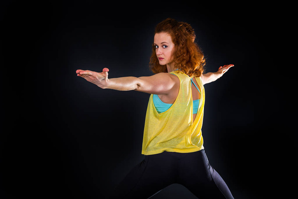yoga trainer in front of black background - Foto, Imagem
