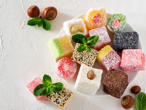 Turkish delight on white rustic background. Turkish deligh set. Assorted traditional turkish delight on oriental background - 写真・画像