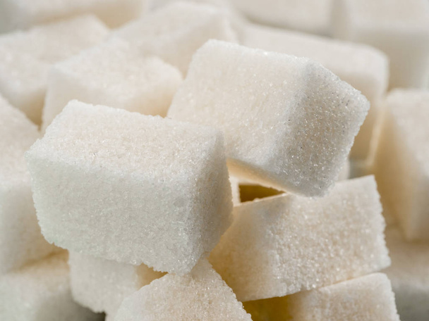 Background of sugar cubes. White cube sugar close up as food background - Fotoğraf, Görsel