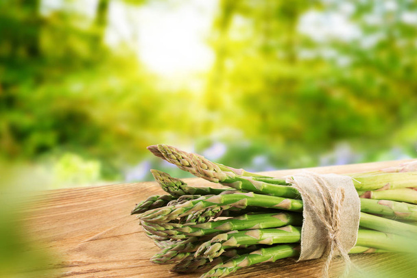 green asparagus in spring on a wooden board - Фото, зображення