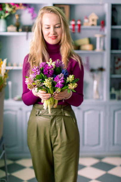 Florist holding a bouquet. Beautiful spring flowers. Arrangement with mix flowers. The concept of a flower shop, a small family business. Work florist. copy space - Photo, image