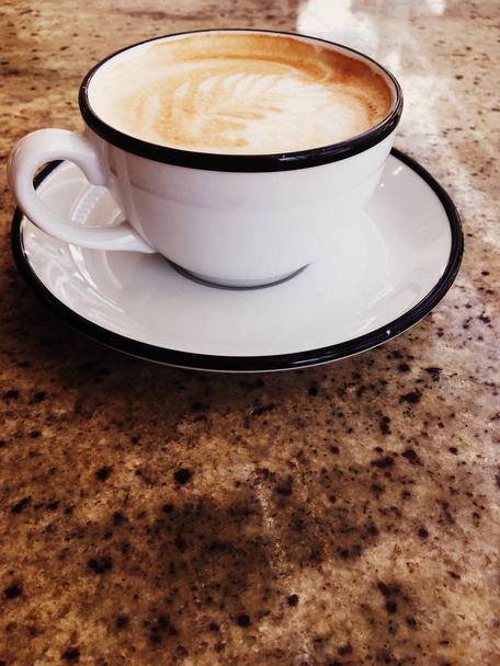 Cappuccino for breakfast in cafeteria, coffee cup on table in pa - Photo, Image