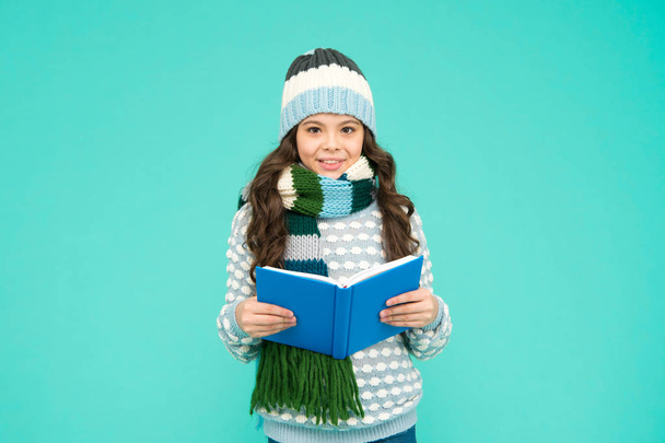 Winter story. Girl reading book. Kid enjoying book. Little book lover. My favorite story. Leisure in winter time. Childhood development. Interesting information. Library concept. Reading skills - Photo, image