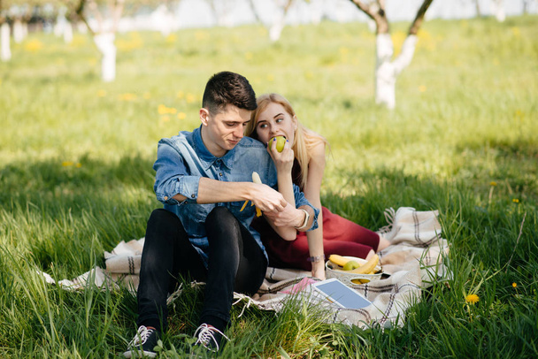 Beautiful couple spend time in a summer park - Fotó, kép