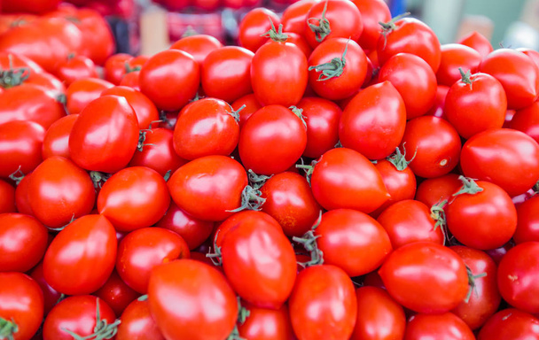 Fresh red ripe cherry tomatoes on the farmers market stand. - Fotó, kép
