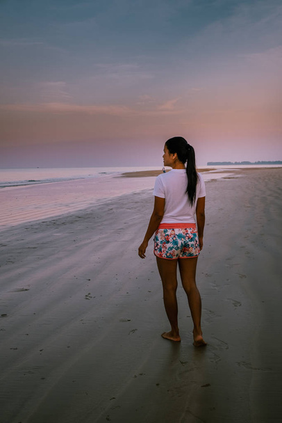 nainen kävelee rannalla auringonnousun aikana Khao Lak Thaimaa
 - Valokuva, kuva
