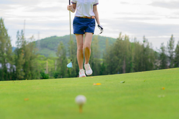 woman golf player in checking line to hit the ball to fairway, walking to hit the golf ball after line checking target - Φωτογραφία, εικόνα