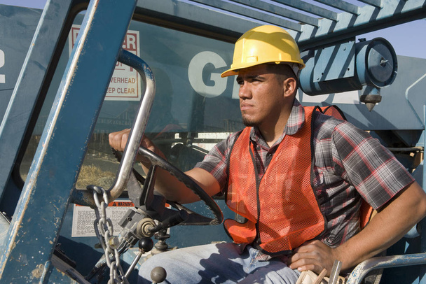 Man driving bulldozer at construction site - Fotoğraf, Görsel