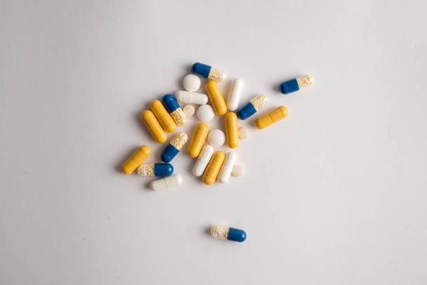 Different tablets, pills, medications drugs on white background - Fotó, kép