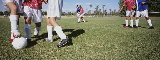 Rival female soccer players tackling football - Valokuva, kuva