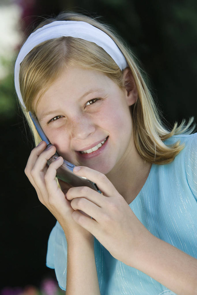 Portrait of happy teenage girl using cellphone - Foto, Imagen