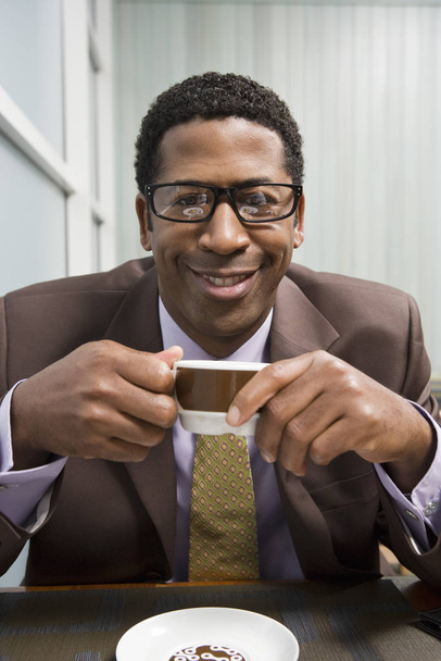 Portrait of an African American man drinking coffee - Foto, afbeelding