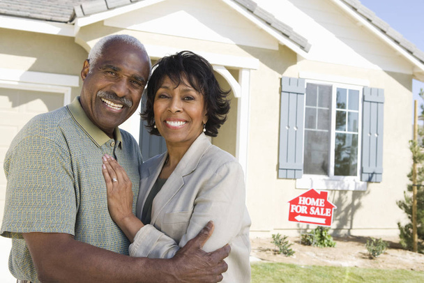 Portrait of happy African American couple in front of home for sale - Zdjęcie, obraz