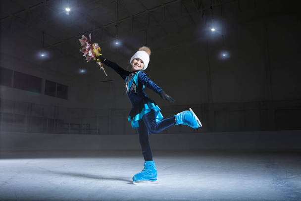 view of child  figure skater on dark ice arena background - Photo, image