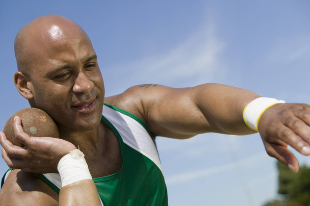 African American male athlete ready to throw shot put - Foto, imagen